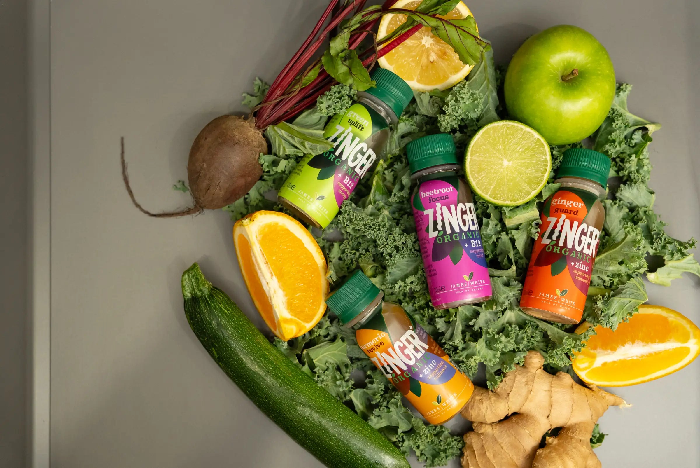 Zinger Organic shots surrounded by colourful fruit and vegetables